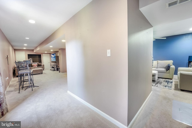 corridor with light colored carpet