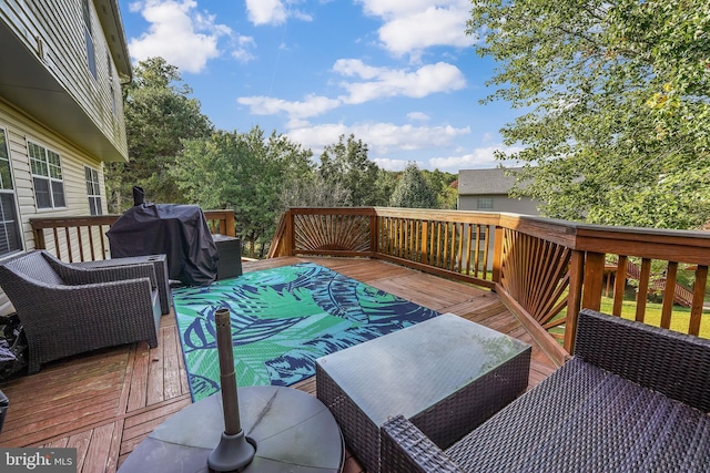 wooden terrace featuring a grill