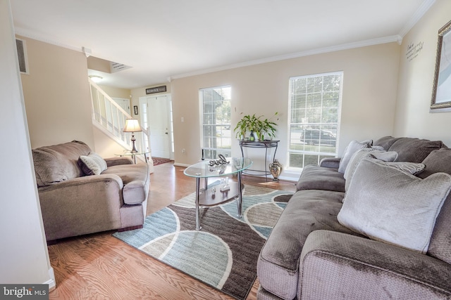 living room featuring wood-type flooring and ornamental molding