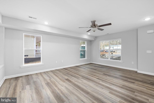 empty room featuring ceiling fan and light hardwood / wood-style floors