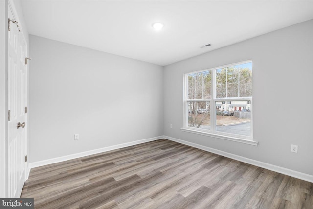 spare room featuring light wood-type flooring