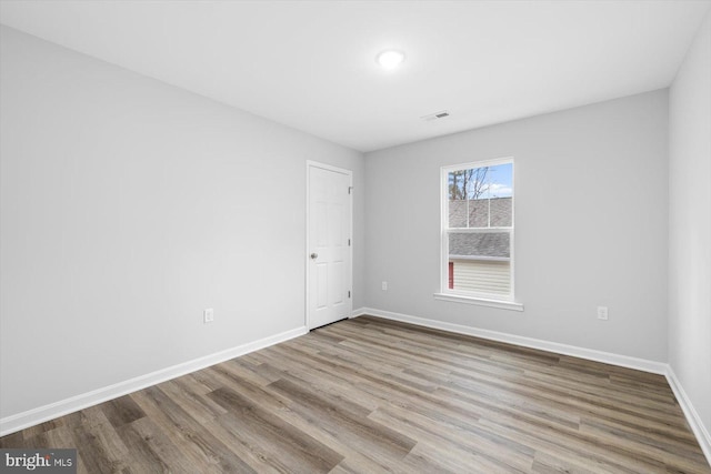 spare room with light hardwood / wood-style flooring