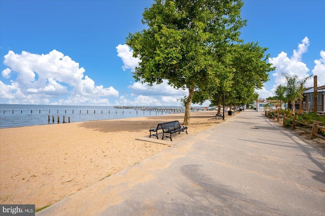 view of property's community featuring a water view and a view of the beach