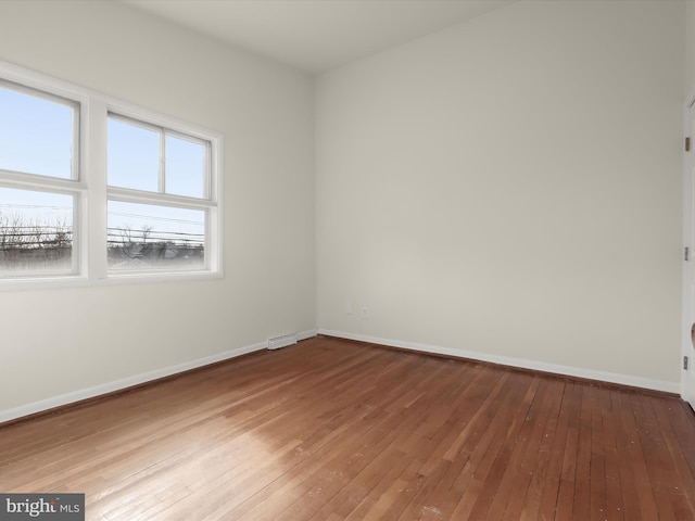 spare room with wood-type flooring