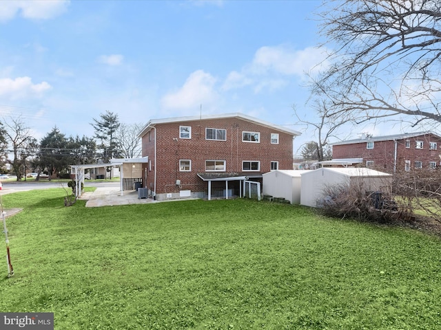 rear view of property featuring central AC unit and a lawn