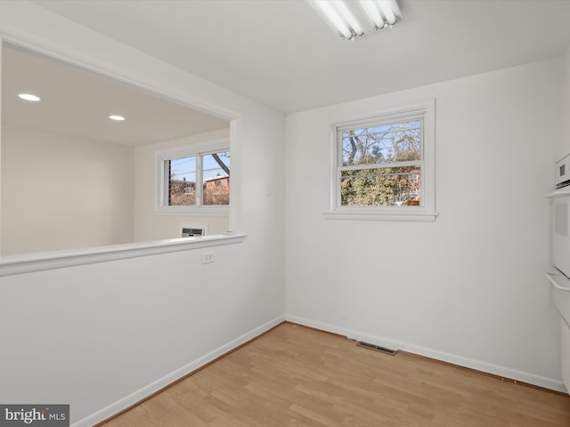 spare room featuring light wood-type flooring