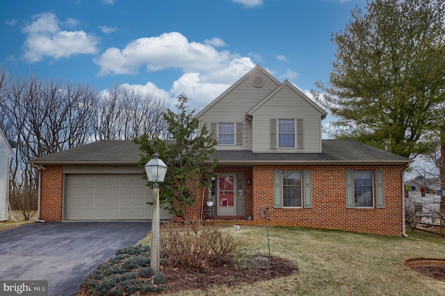 traditional home featuring aphalt driveway, a front yard, brick siding, and a garage