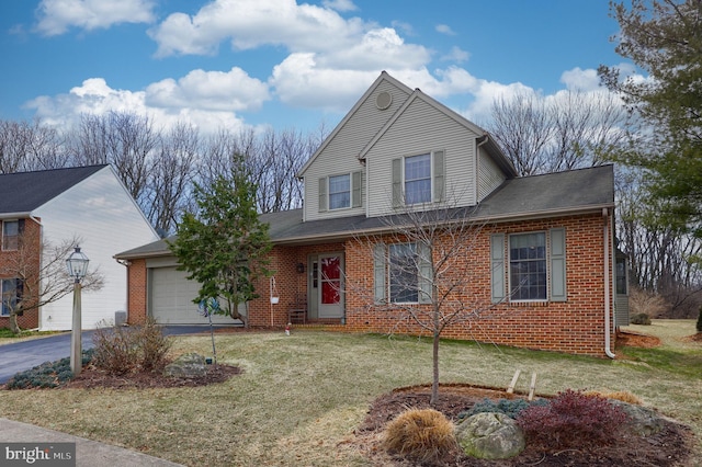 traditional-style house featuring driveway, brick siding, a front lawn, and an attached garage