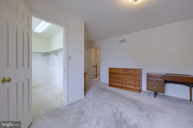 unfurnished bedroom featuring carpet flooring and visible vents