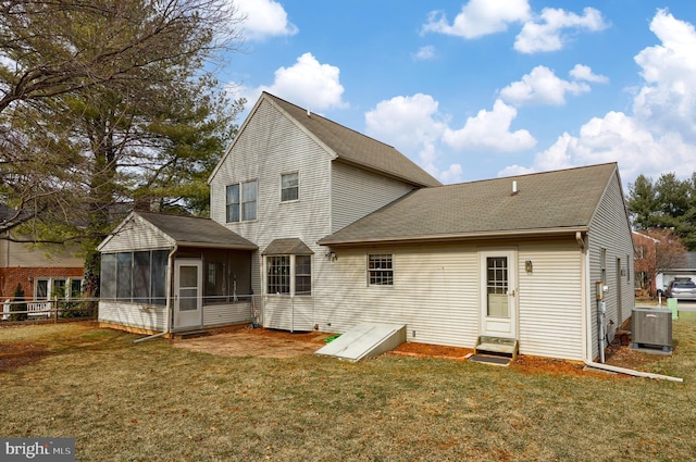 back of property with entry steps, a yard, fence, and a sunroom