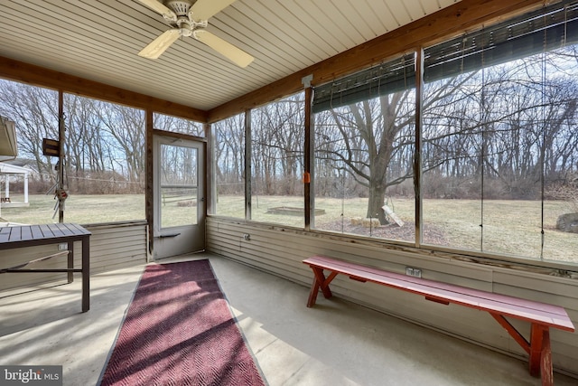 unfurnished sunroom featuring ceiling fan