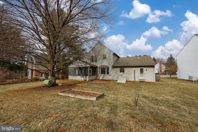 back of property with cooling unit, fence, a sunroom, a yard, and stone siding