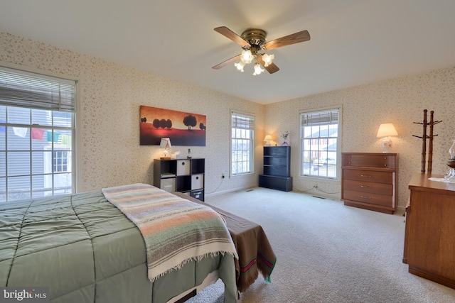 bedroom featuring ceiling fan, carpet flooring, and wallpapered walls