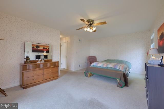 bedroom with baseboards, carpet flooring, a ceiling fan, and wallpapered walls