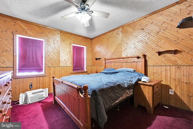 bedroom with a textured ceiling, carpet floors, ceiling fan, and wooden walls