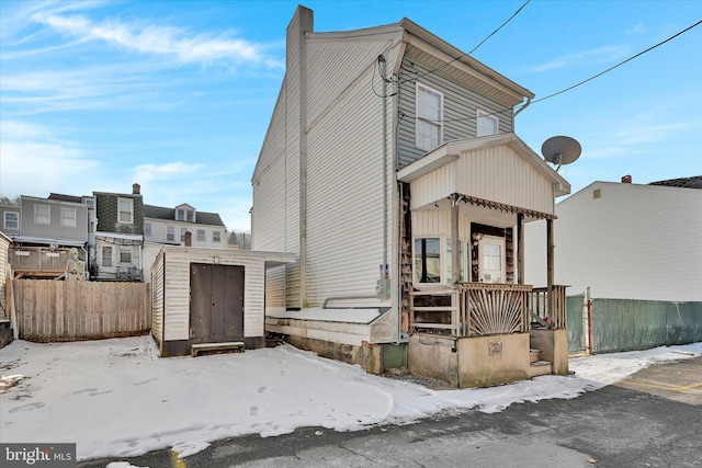 view of front of property with a storage shed