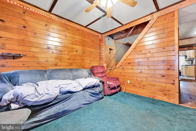 unfurnished bedroom with carpet flooring, ceiling fan, wood walls, and a textured ceiling