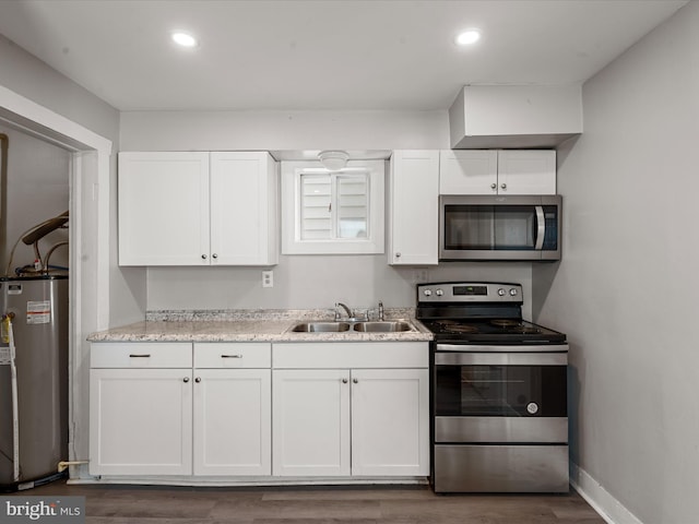 kitchen with sink, white cabinets, water heater, and stainless steel appliances