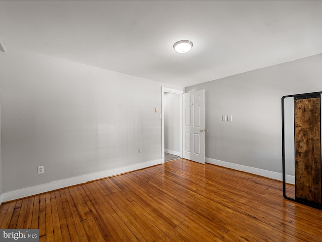 unfurnished room featuring hardwood / wood-style flooring