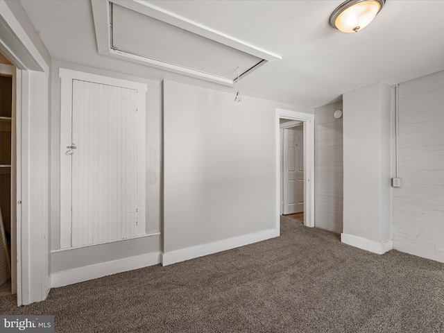 unfurnished bedroom featuring dark carpet