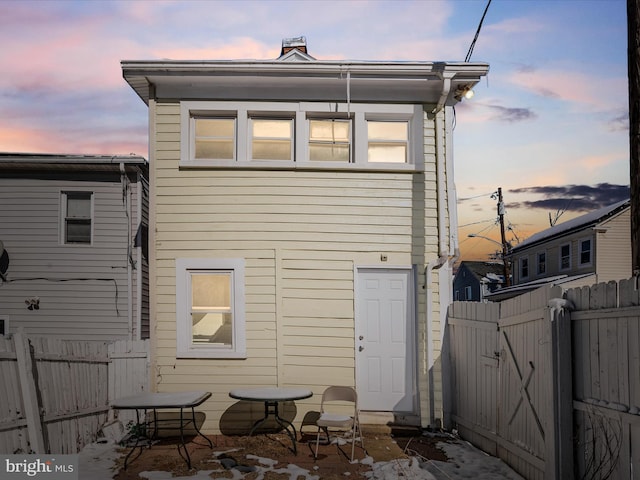 view of back house at dusk