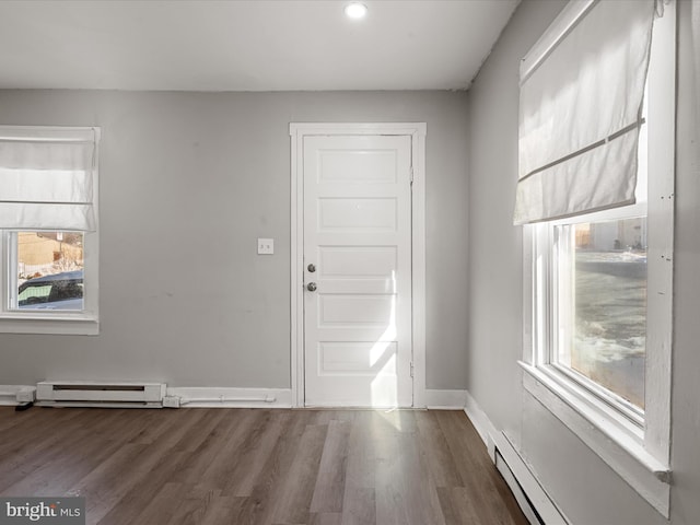 entryway featuring hardwood / wood-style flooring and a baseboard heating unit