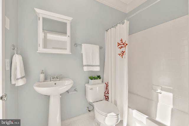 bathroom with ornamental molding, shower / tub combo with curtain, and toilet