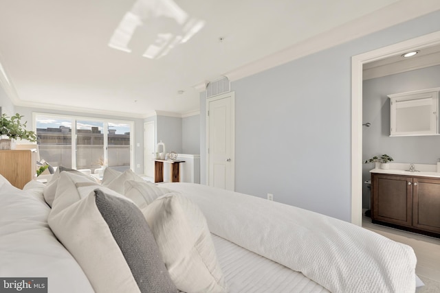 bedroom with sink and crown molding