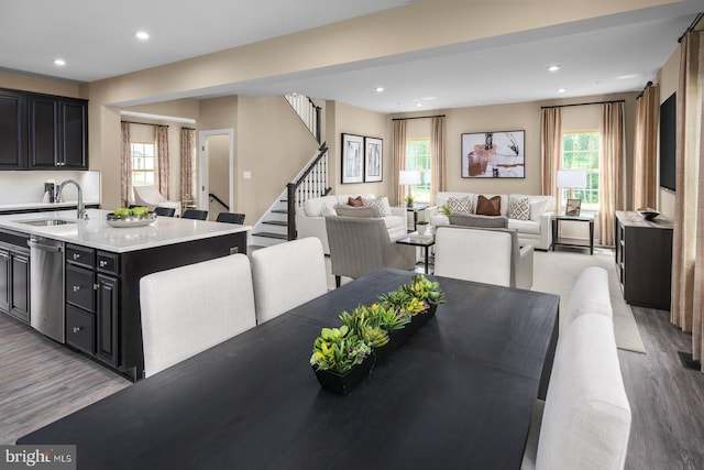 dining room with sink, light hardwood / wood-style flooring, and plenty of natural light