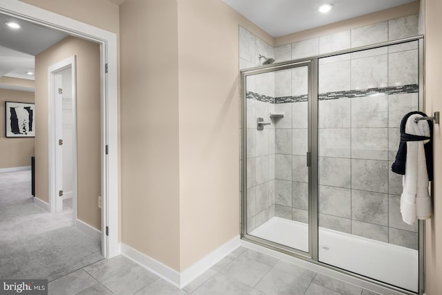 bathroom with tile patterned flooring and a shower with shower door