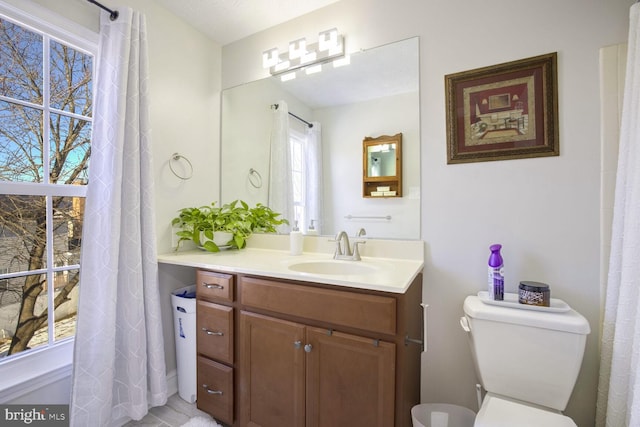 bathroom with toilet and vanity