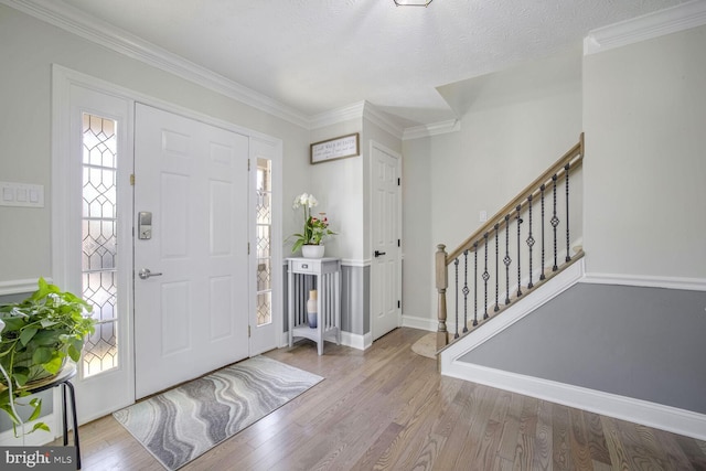 entryway featuring crown molding and hardwood / wood-style flooring