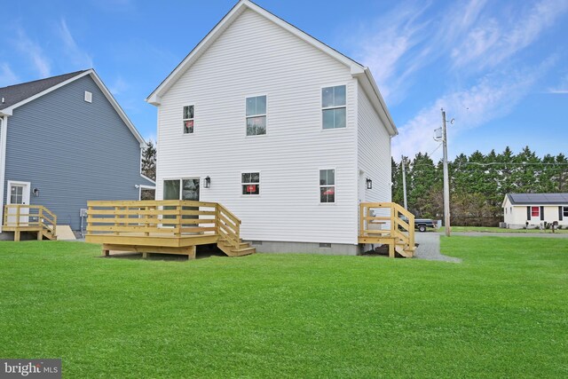rear view of property featuring crawl space, a wooden deck, and a lawn