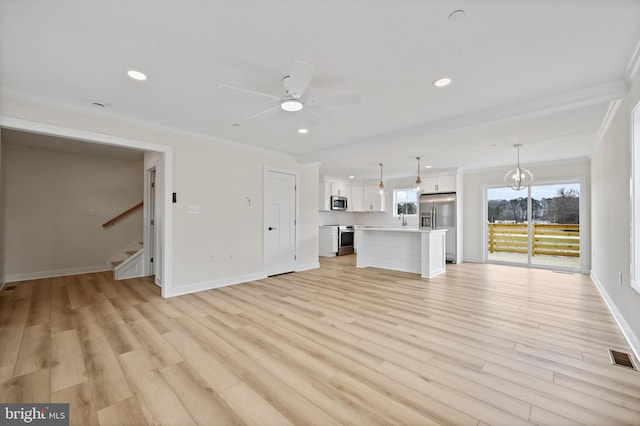 unfurnished living room with ceiling fan, ornamental molding, and light hardwood / wood-style floors