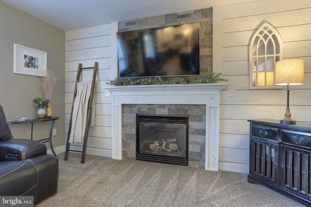 living room featuring wooden walls and carpet