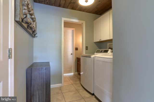 washroom with independent washer and dryer, cabinets, light tile patterned floors, and wooden ceiling