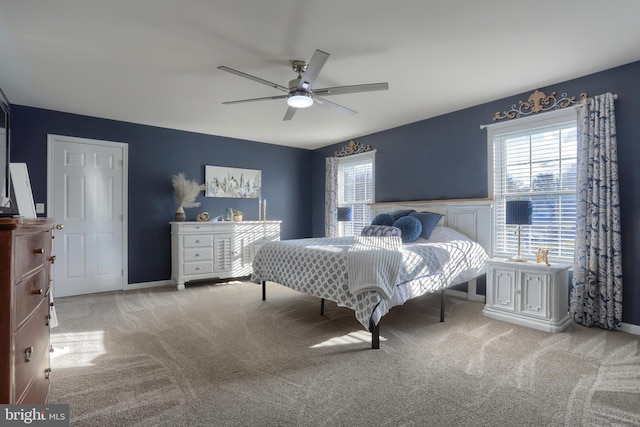 bedroom with ceiling fan and light carpet