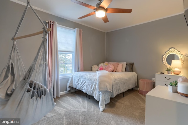 bedroom with ceiling fan, crown molding, and carpet flooring