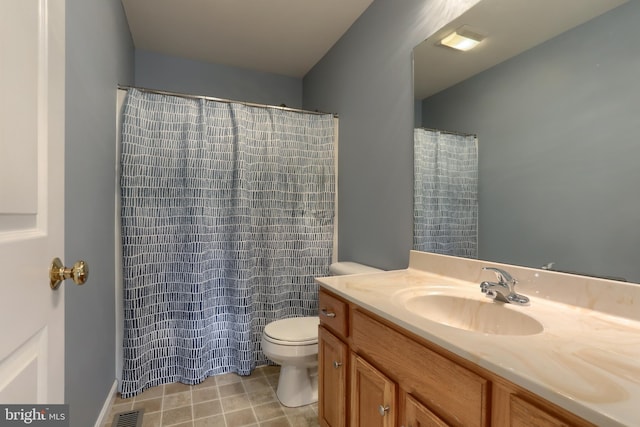 bathroom with toilet and vanity