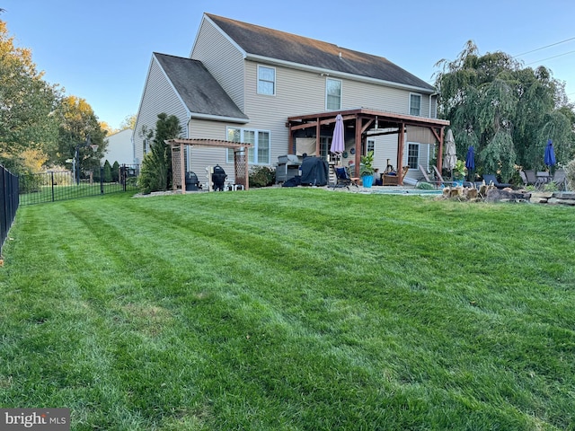 back of property featuring a lawn, a patio area, and a pergola