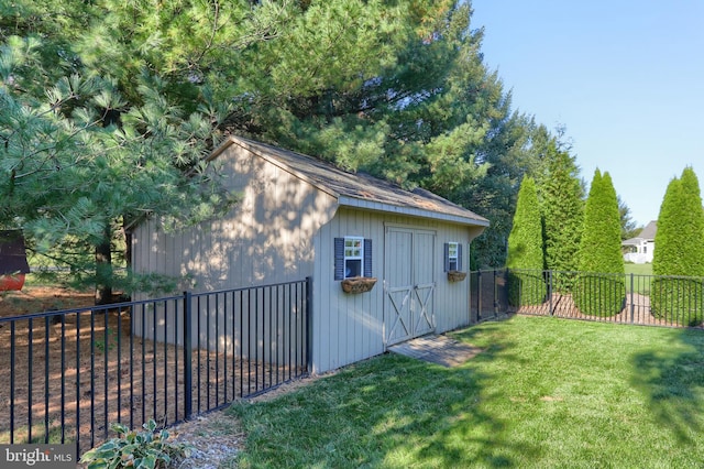 view of outbuilding featuring a lawn