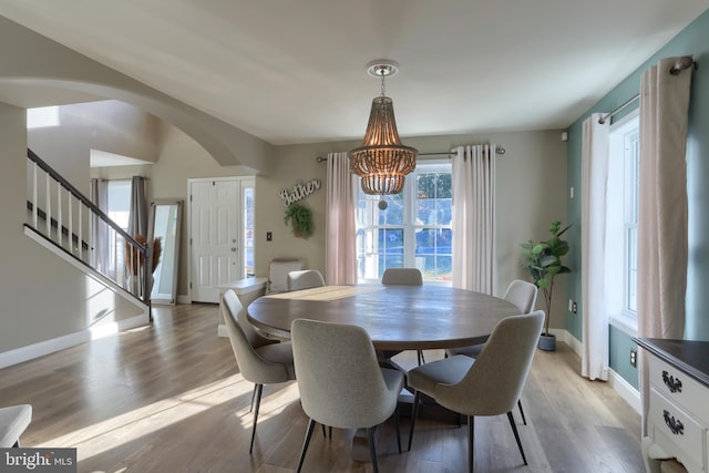 dining area with a chandelier and light hardwood / wood-style flooring