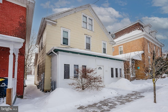 view of snow covered rear of property