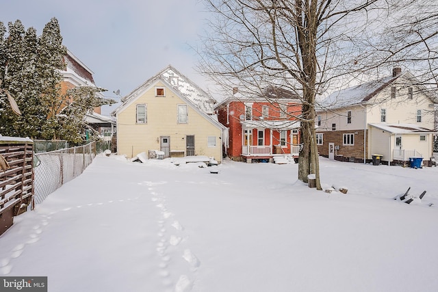 view of snow covered rear of property