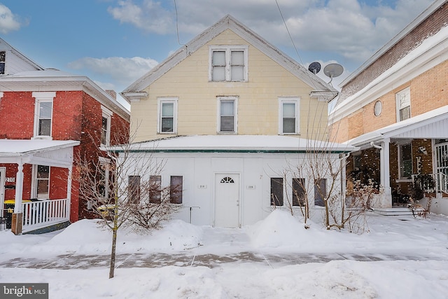 view of snow covered rear of property