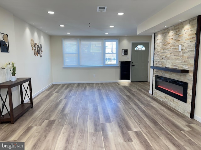 unfurnished living room featuring light hardwood / wood-style floors and a fireplace