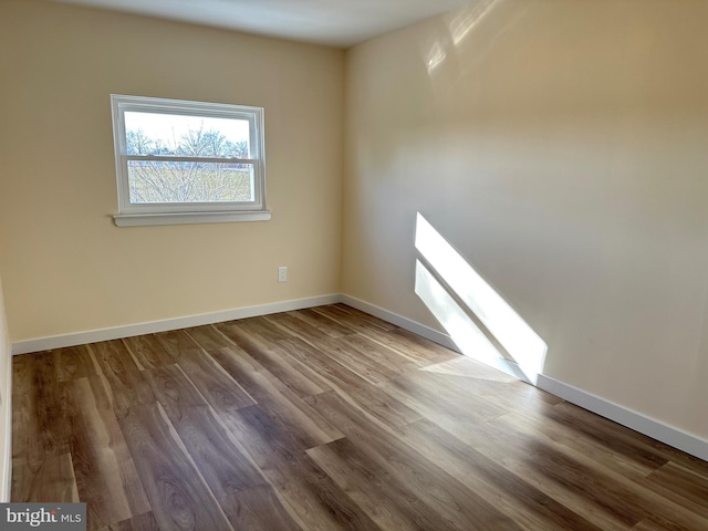 unfurnished room with hardwood / wood-style floors