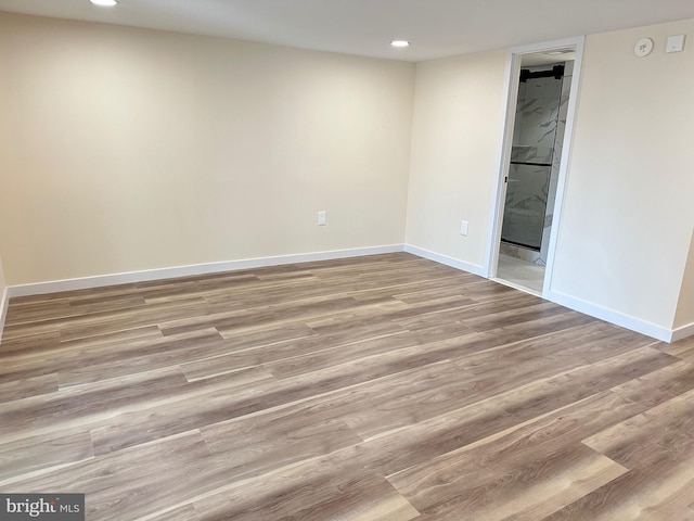 unfurnished room with light wood-type flooring