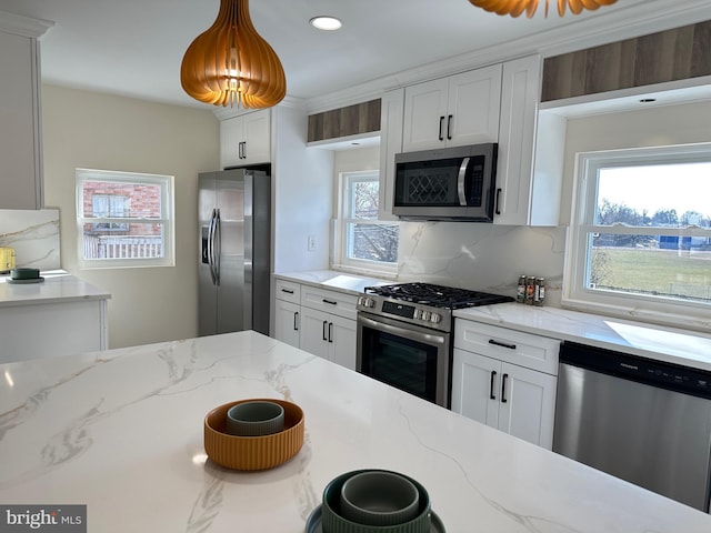 kitchen with stainless steel appliances, decorative backsplash, white cabinets, and light stone counters