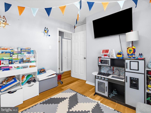 playroom featuring light wood-type flooring